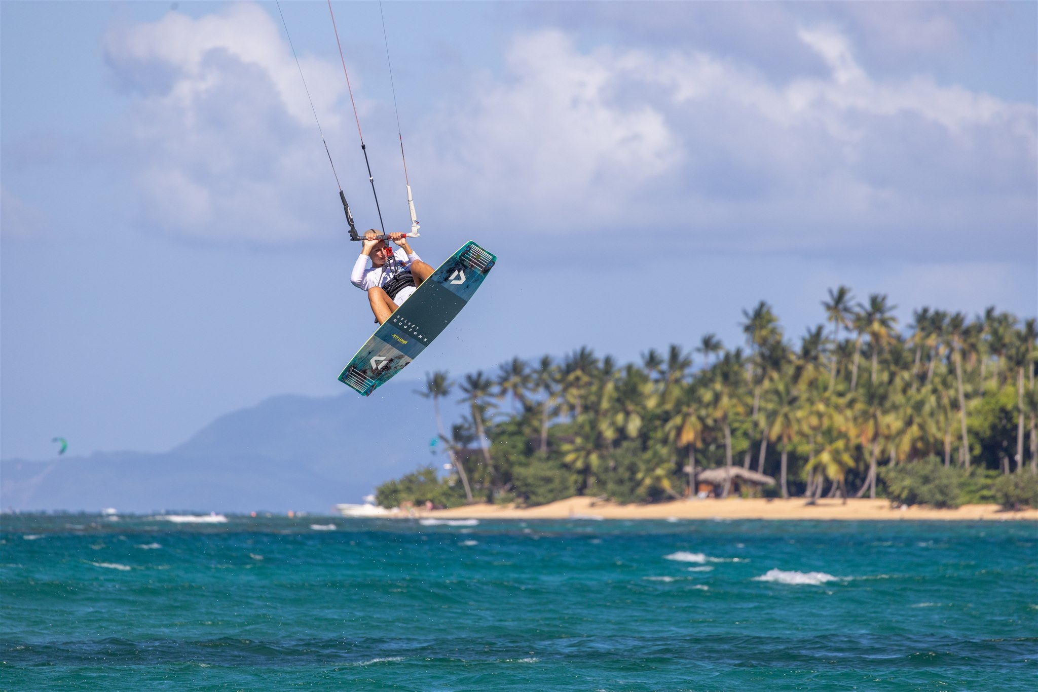 Kiteboarder posing on Cabarete Beach with a vibrant kite.